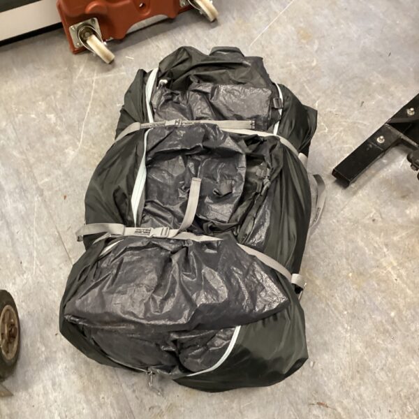 Collapsed Outdoor Revolution Cayman Midi Air camping tent, ready for storage.