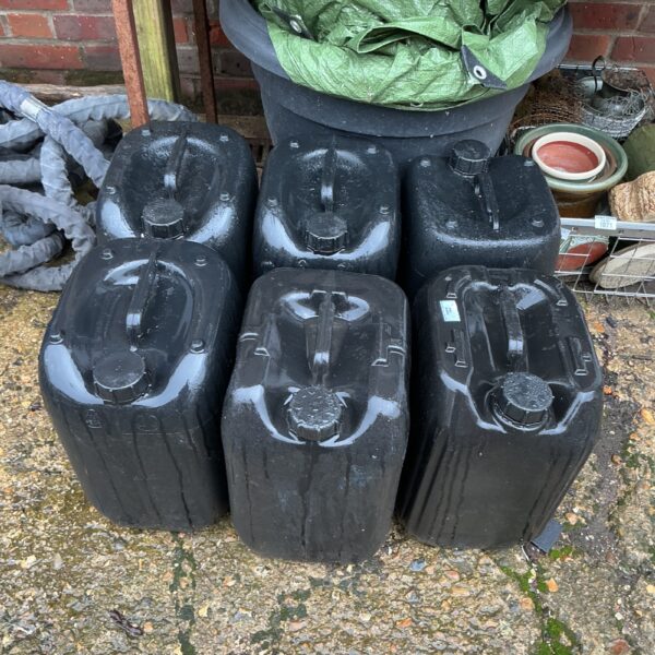 Lot of six plastic water cans for storage and transport.