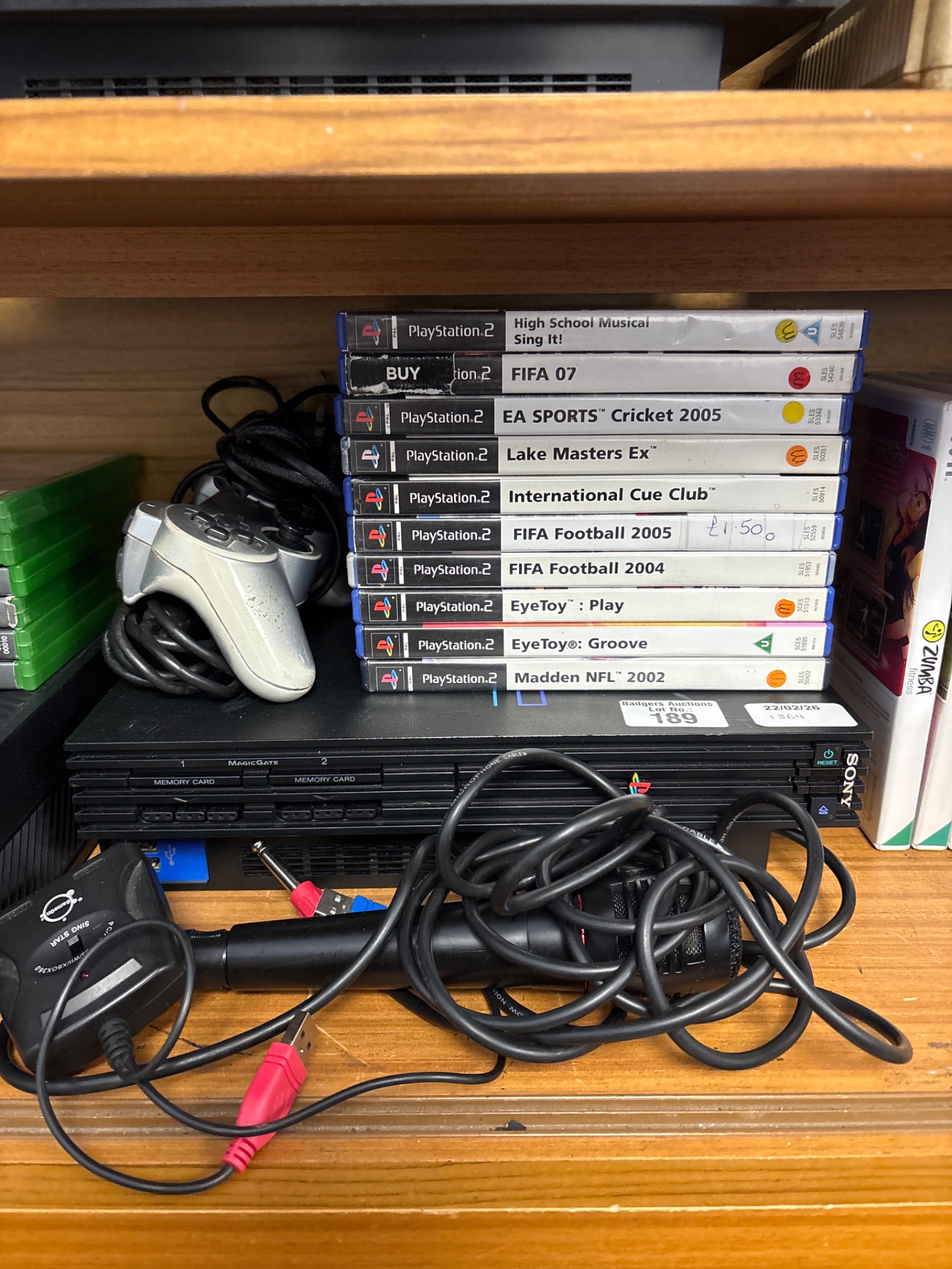 189 Sony PlayStation two console with controller and games