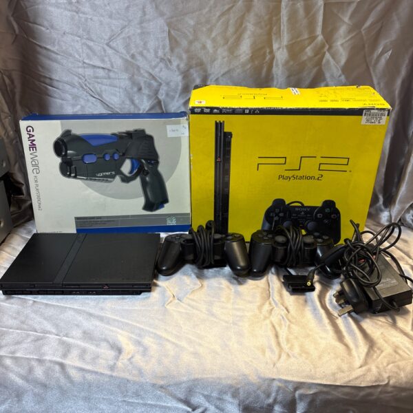 Boxed Sony PlayStation 2 Slim console with wireless light gun for retro gaming.
