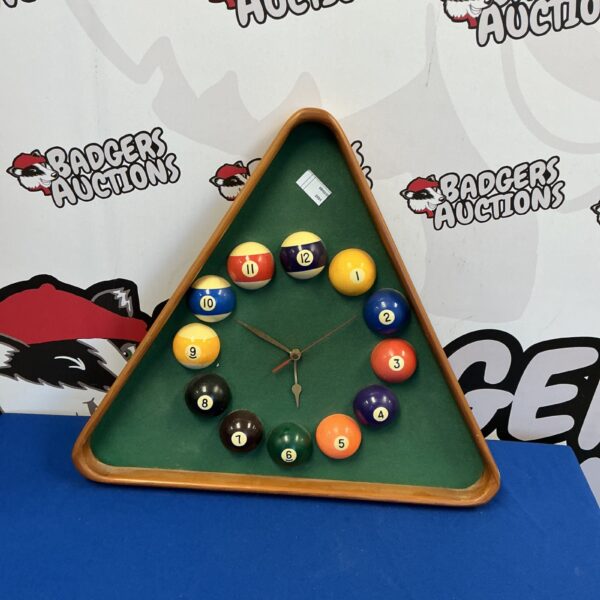 Colourful pool ball wall clock with a green felt background.