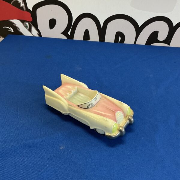 Vintage porcelain Flying Saucer car with red interior.