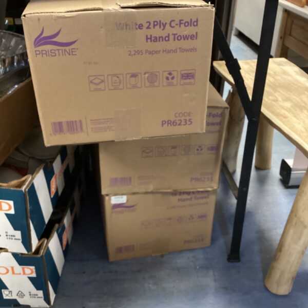 Stack of three boxes of Pristine paper towels for commercial use.