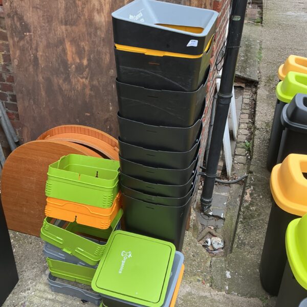 Stack of colourful plastic recycling containers for garden or home use.