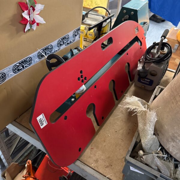 Red worktop jig for woodworking and DIY projects.