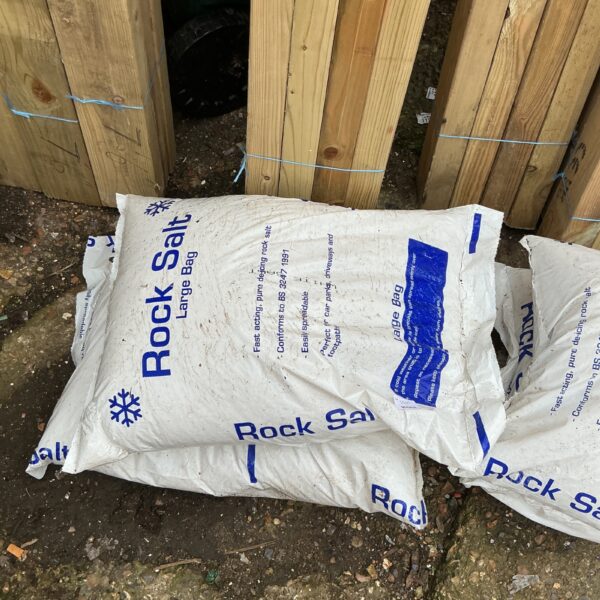 Two bags of rock salt for winter de-icing and snow removal.
