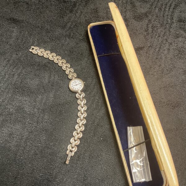 Vintage Rotary silver bracelet watch on a dark surface.