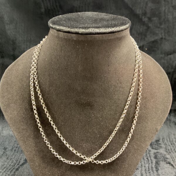 Pair of delicate 925 silver chain necklaces on a display bust.