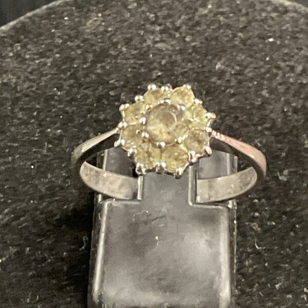 Vintage silver cluster ring with yellow stones.