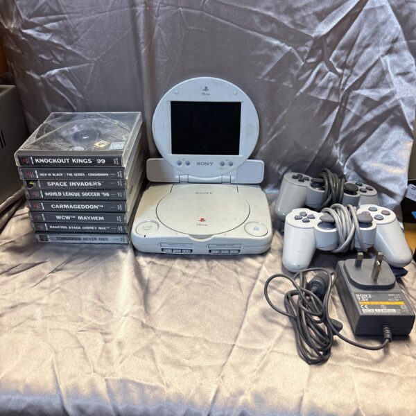 Sony PSone console with LCD screen, controllers, and games.