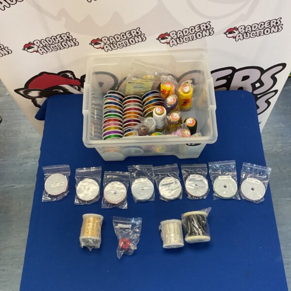 Colourful thread spools and wire lot for crafting projects.