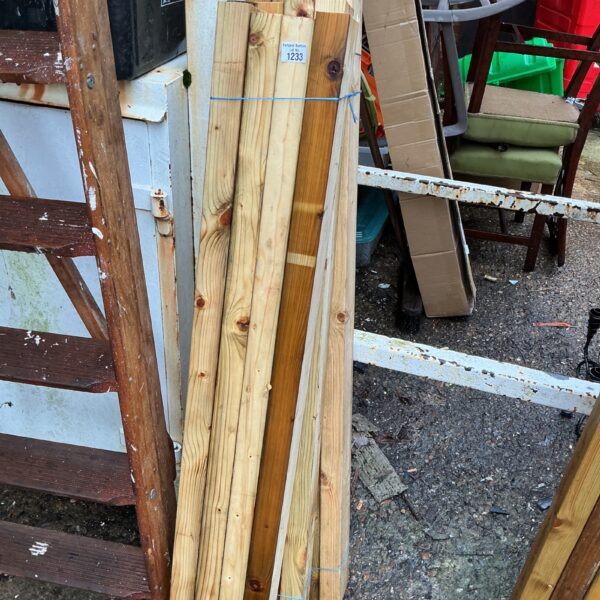 Three bundles of timber stored outdoors, ready for building projects.