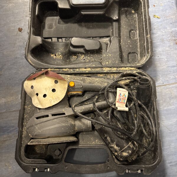Used Titan orbital sander in a workshop setting.