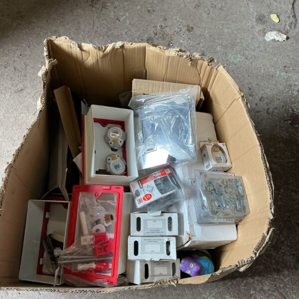Mixed lot of new toilet flush parts and plates for bathroom repairs.