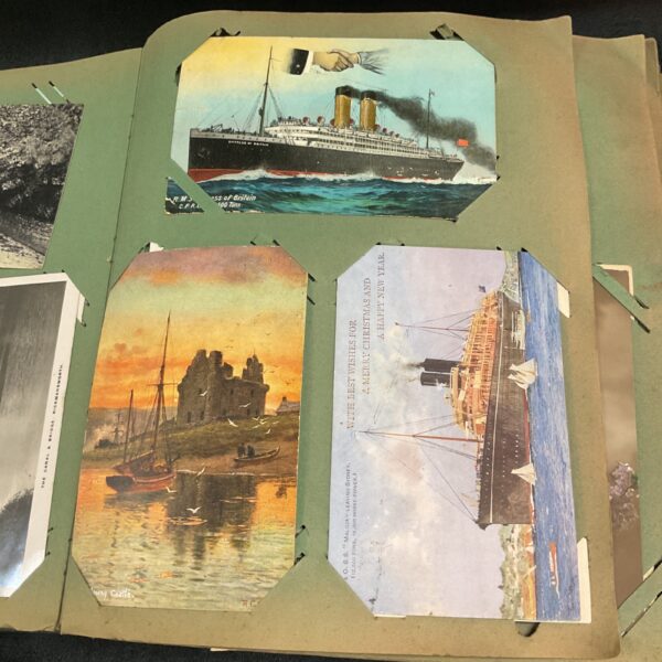 Vintage postcard of a large ship in a Victorian postcard album.