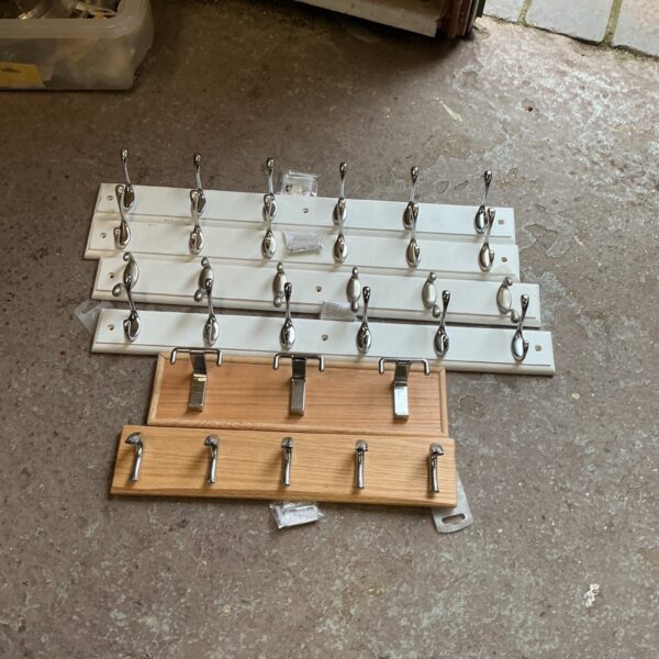Lot of six vintage wooden coat hook racks for hallway storage.