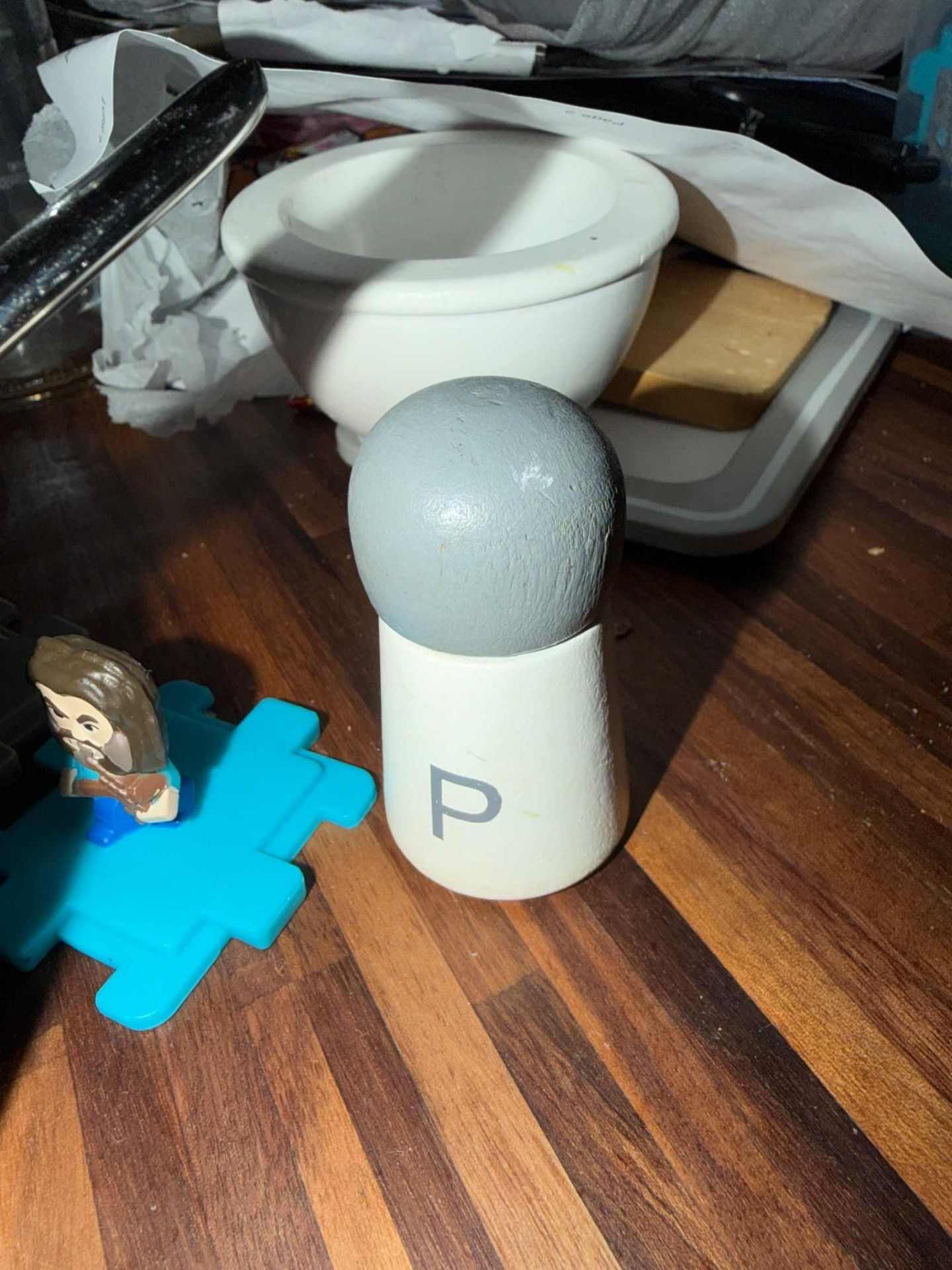 Vintage cotton figurine displayed with a vase and other items.