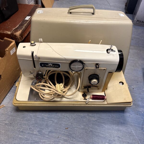 Vintage Crown sewing machine in carrying case, retro sewing equipment.