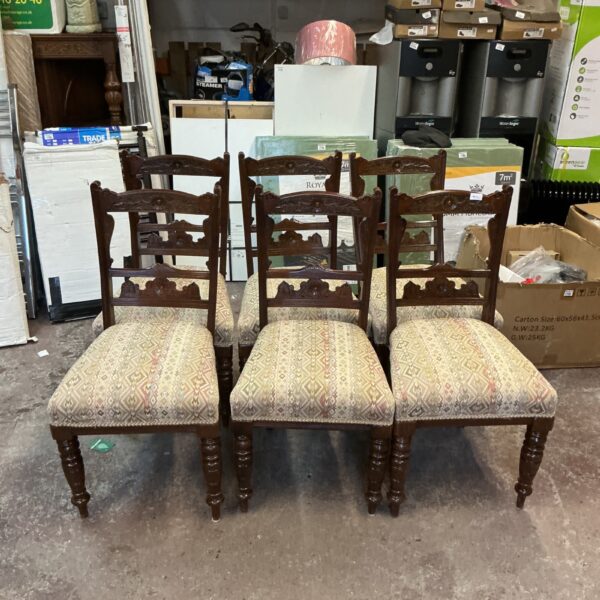 Set of six vintage dining chairs with patterned upholstery.