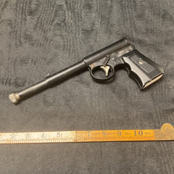 Vintage metal Gat Gun pistol, collectible antique firearm replica.