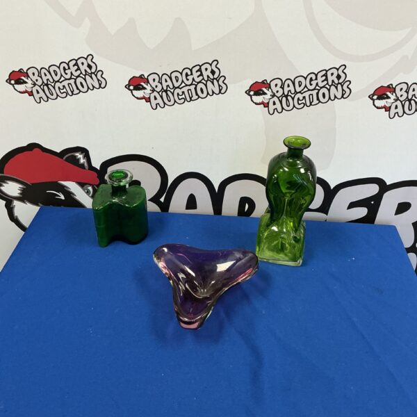 Vintage glass collection featuring a green bottle and fruit bowl.