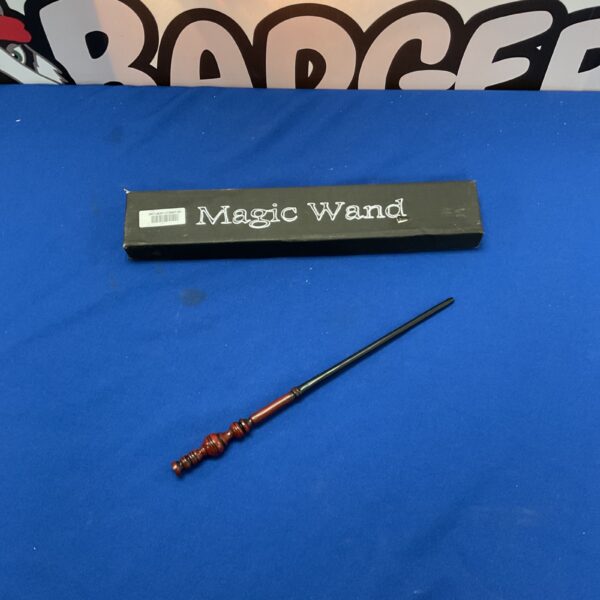 Vintage magic wand with detailed handle and dark wood shaft.