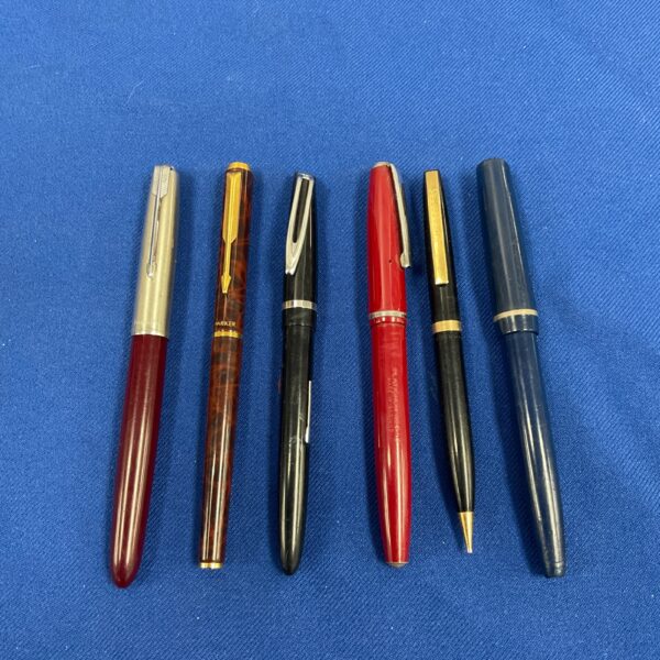 Vintage pen collection featuring fountain and ballpoint pens.