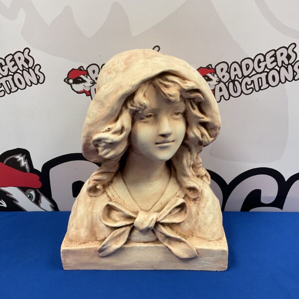 Vintage plaster bust of a young girl wearing a bonnet.