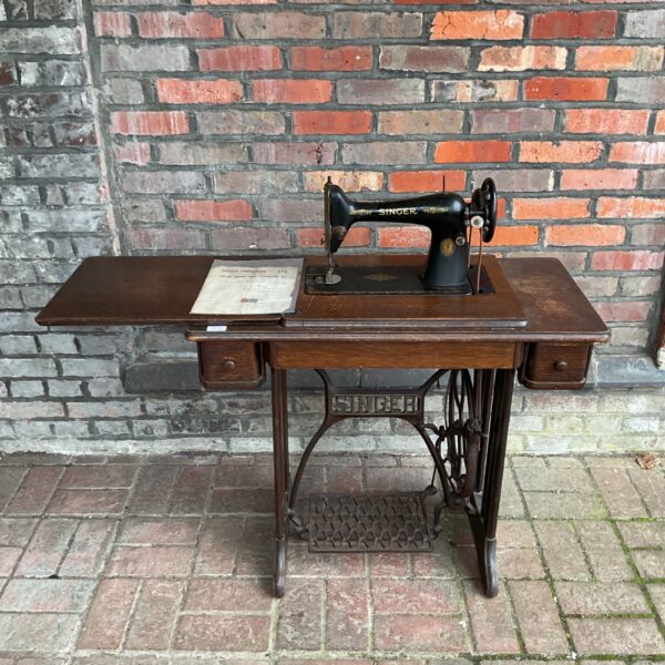 Vintage Singer treadle sewing machine with original receipt.