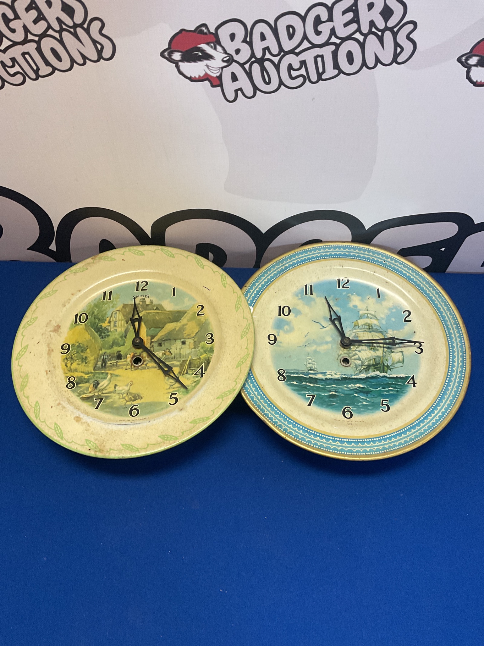 044 Two vintage tin plate smiths quartz wall clocks