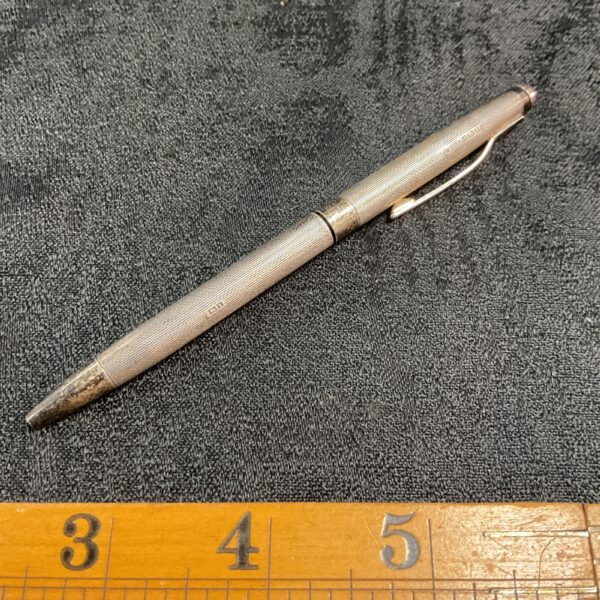 Vintage sterling silver pen with textured detailing.