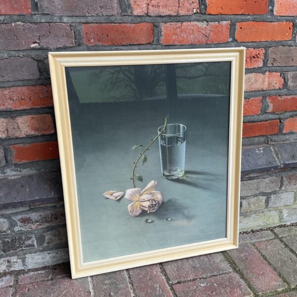 Framed Vladimir Tretchkoff still life print of a rose and water glass.