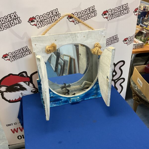 Vintage whale painted cabinet mirror with nautical design.