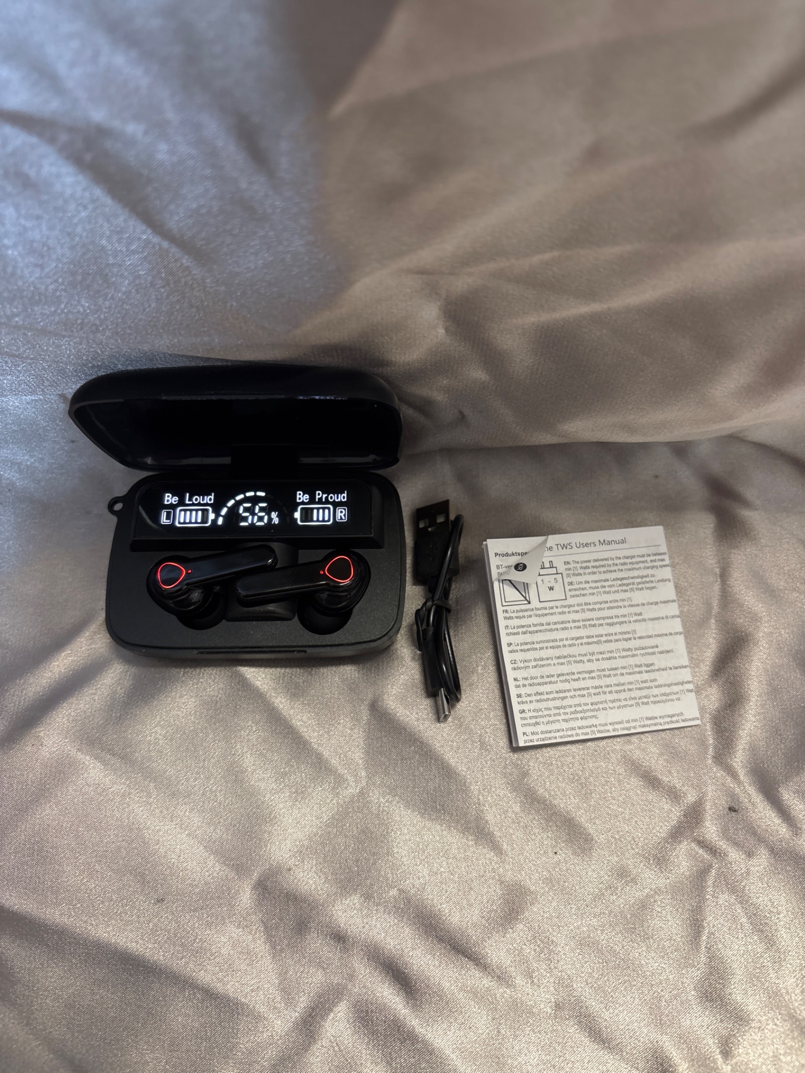 203 Unbranded wireless headphones with charger in case powers on