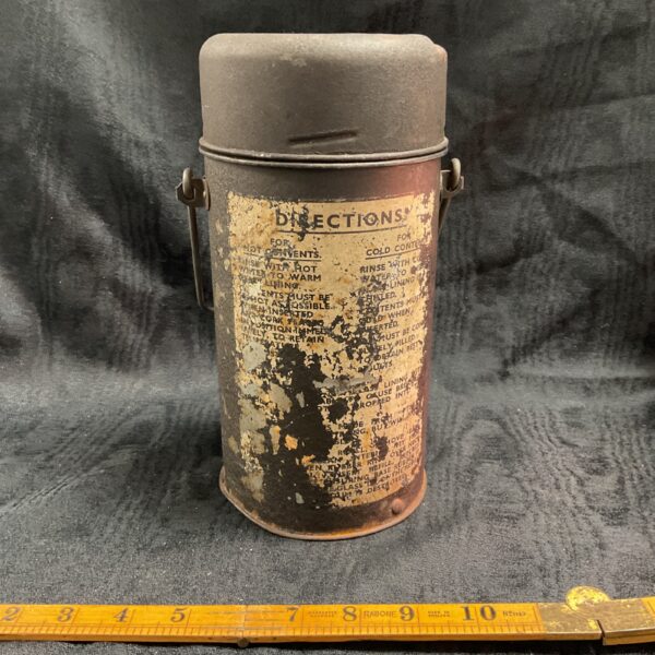 Vintage WW2 Lancaster bomber flask with faded instructions.