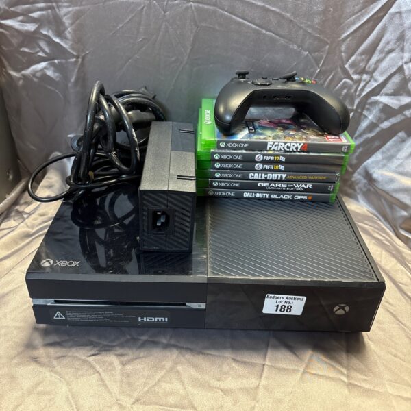 Microsoft Xbox One console with controller and game titles.