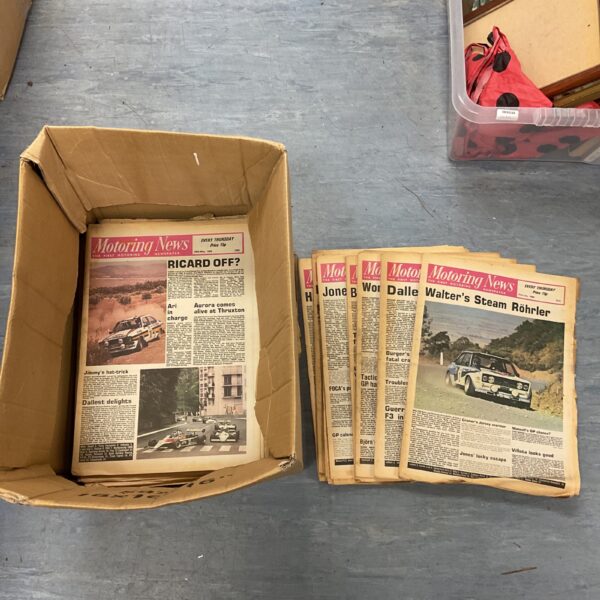 Stack of vintage 1980s motoring news newspapers for collectors.