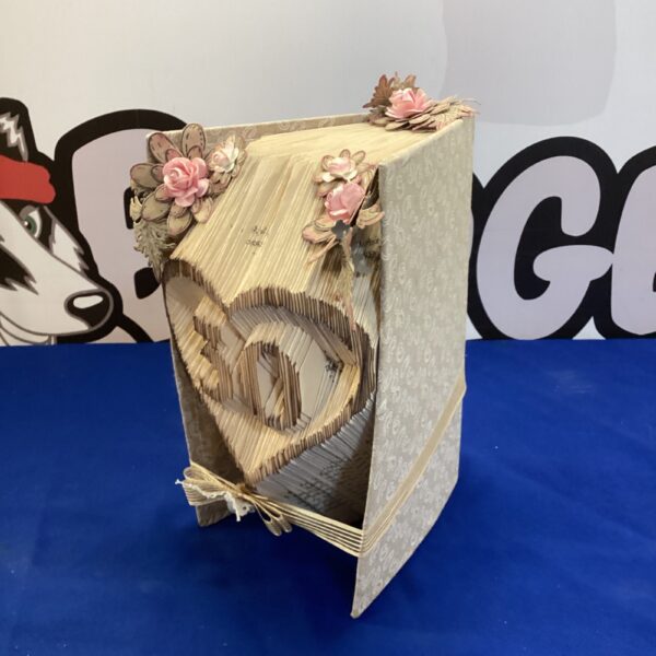 Decorative 30th birthday book display with floral accents.