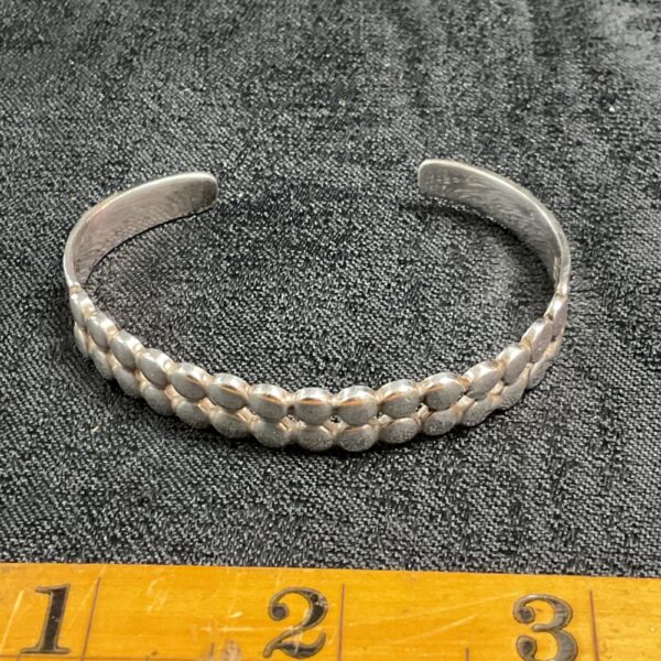 Close-up of a 925 silver snake chain bracelet.