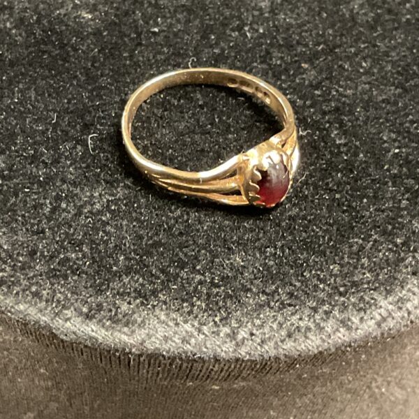 Close-up of a 9ct gold garnet ring, size E.