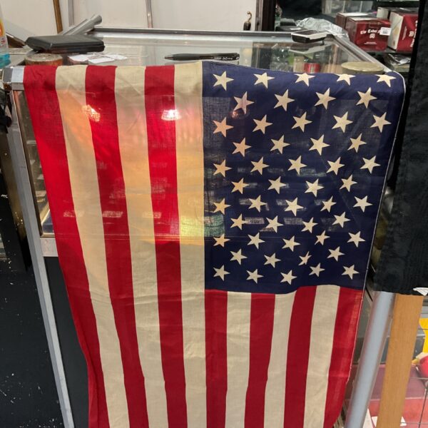 Small American vehicle flag with stars and stripes design.