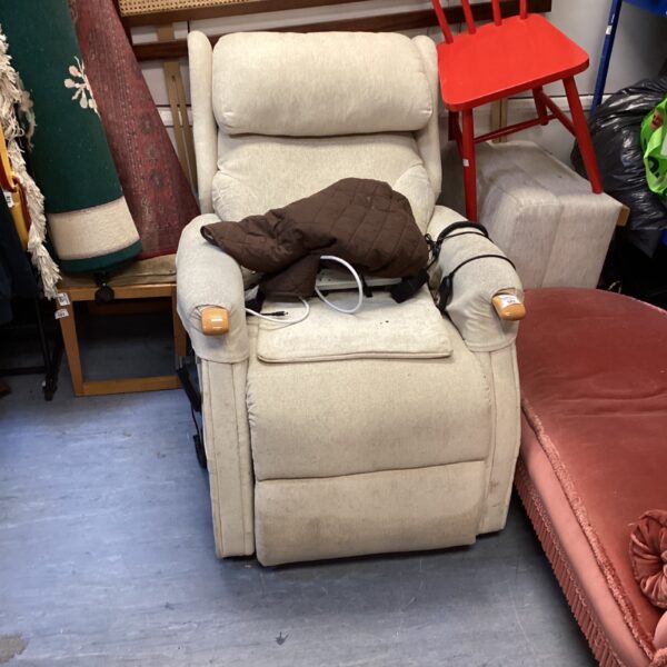Beige electric reclining armchair in a home setting.