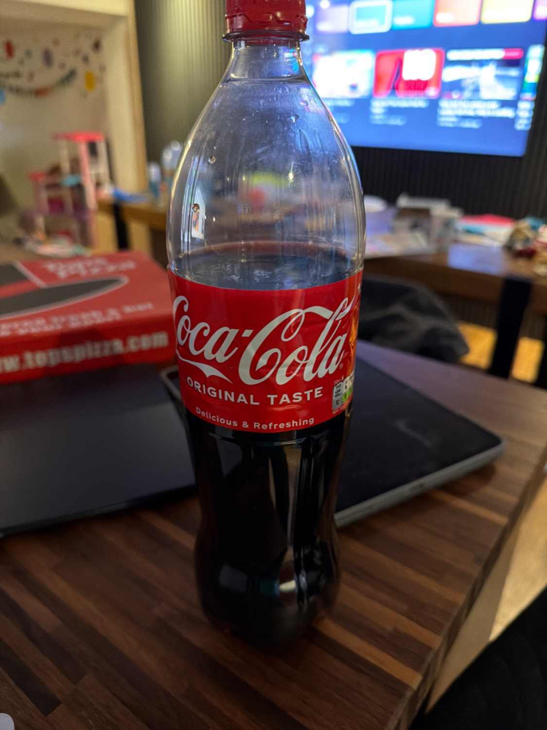 Vintage Coca-Cola bottle, clear glass, iconic branding.