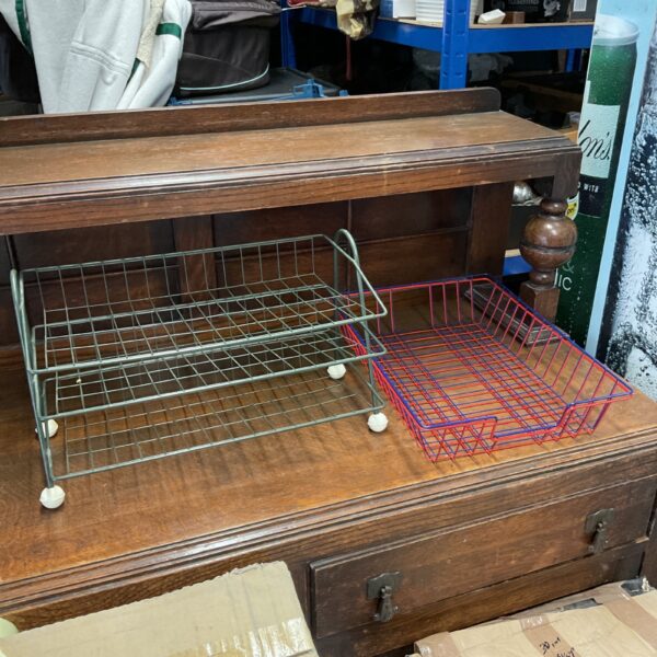 Three dark metal filing trays for desk organisation.