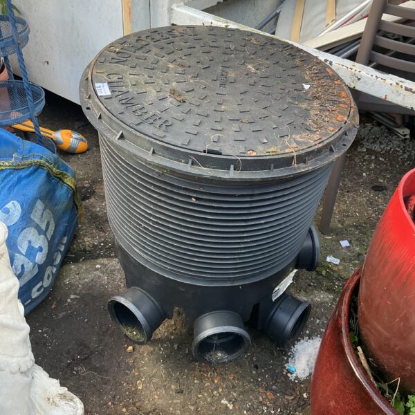 Plastic drain inspection chamber for underground drainage access.