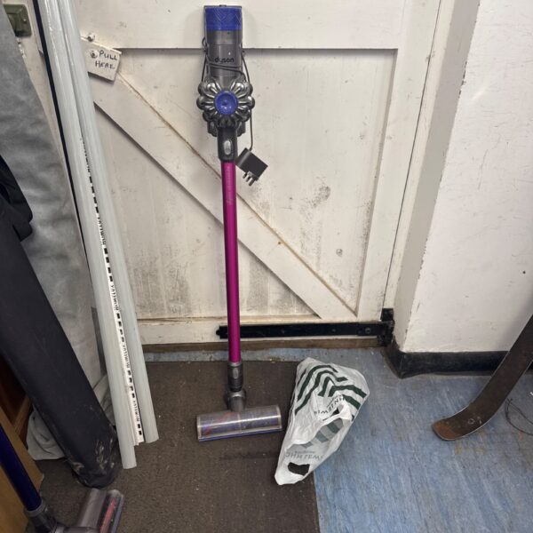 Front view of a purple Dyson V6 Absolute cordless vacuum cleaner.