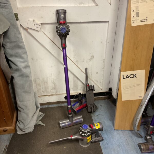 Two Dyson V7 cordless vacuum cleaners for home cleaning.