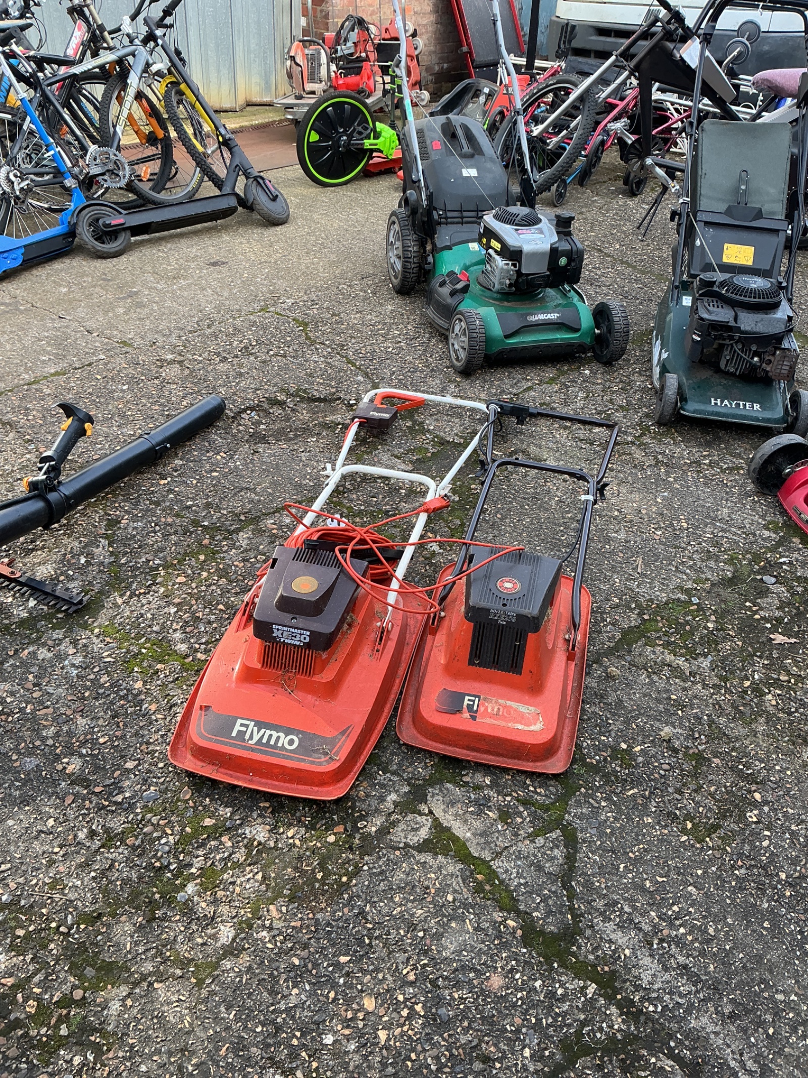 1353 Two Flymo electric lawnmowers with power cable