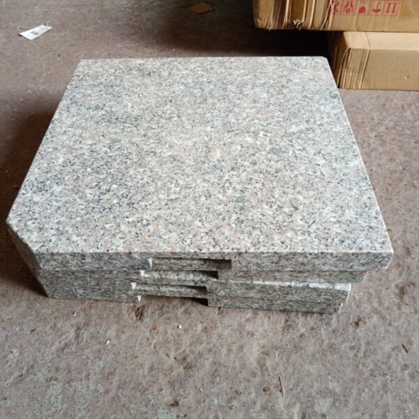Set of four granite parasol bases for outdoor use.