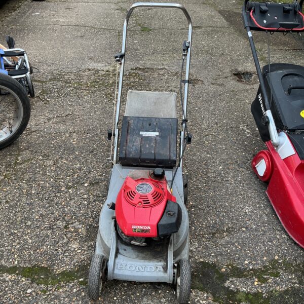 Used Honda HR173 petrol mower in a garden setting.